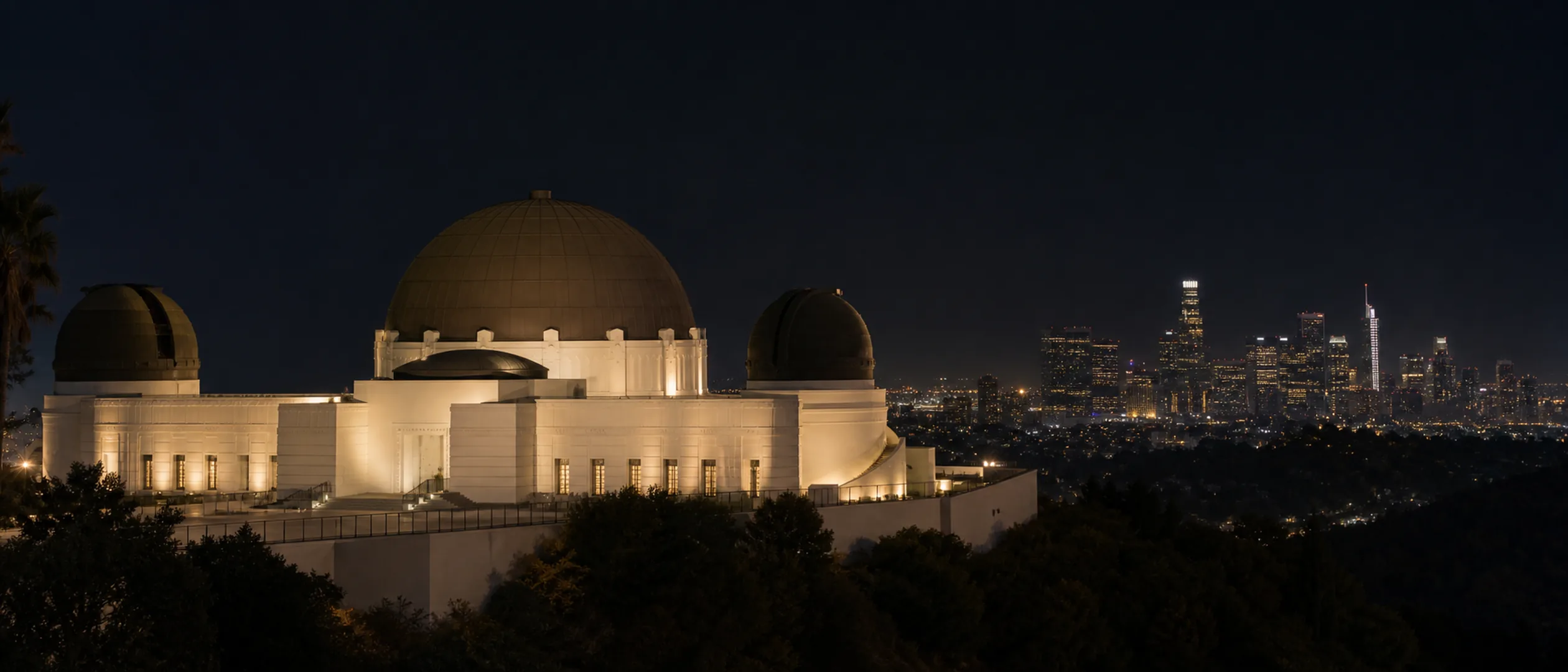 Griffith Observatory overlooks the Los Angeles basin and downtown skyline at blue hour.